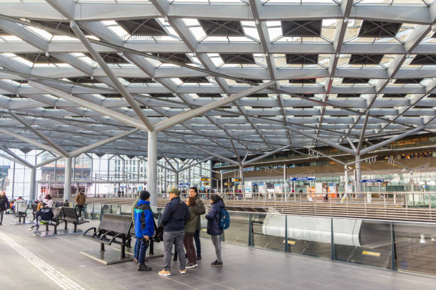 passengers waiting in The Hague central station The Hague, the Netherlands - February 24 2018: tram platform at The Hague central train, bus and tram station tasrail stock pictures, royalty-free photos & images