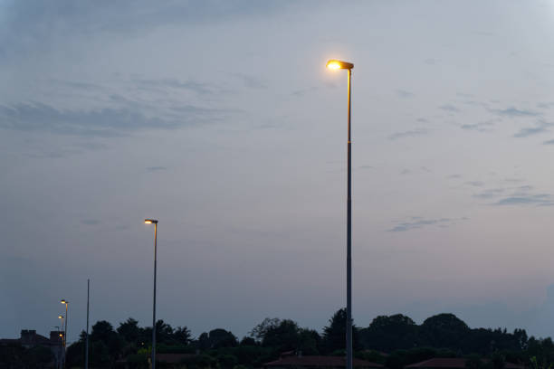 istock Street lamp lights on empty footpath in evening 1030922142