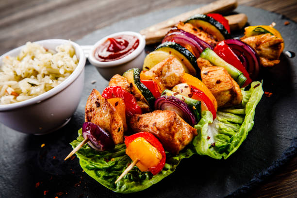 istock Kebabs - grilled meat and vegetables on wooden background 1030925068