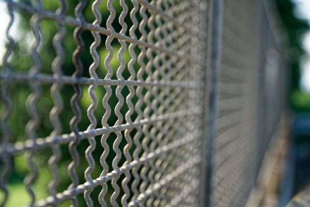 istock Metal fence with mesh, railroad on background 1030925206
