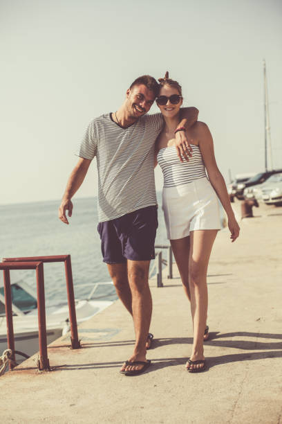 istock Happy couple walking along the shore 1030926170