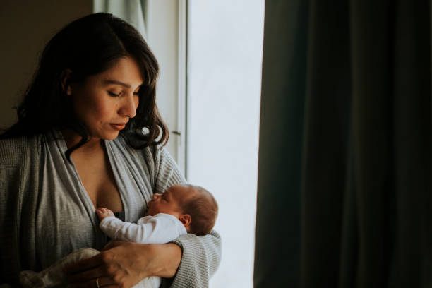 istock Mother holding her baby indoors 1030926466