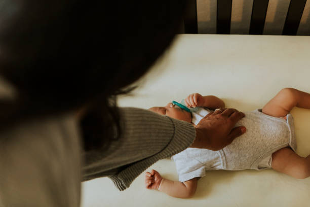 istock Mother looking after a sleeping baby 1030926616