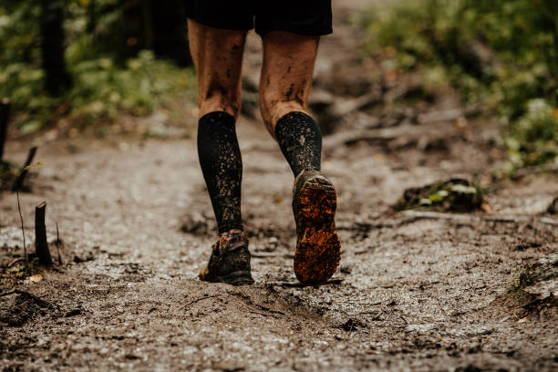 istock back dirty feet athlete runner running on trail in forest 1030927116