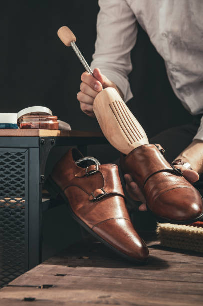 istock Bootblack prepares shoes for cleaning in his workshop 1030927132