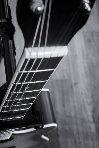 istock acoustic guitar on a wooden background.grain and noise effect 1030936412
