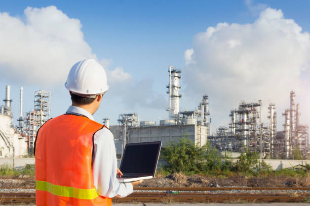 istock Maintenance engineer working with laptop in oil refinery 1030940560