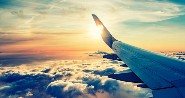 istock flying and traveling, view from airplane on sunset time 1030941110