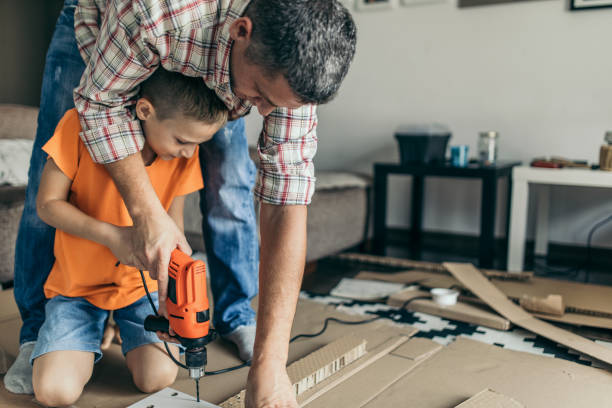 Single father is assembling furniture with his kids