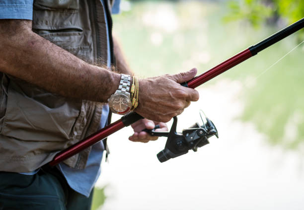 istock Man fishing by a lake 1030945086