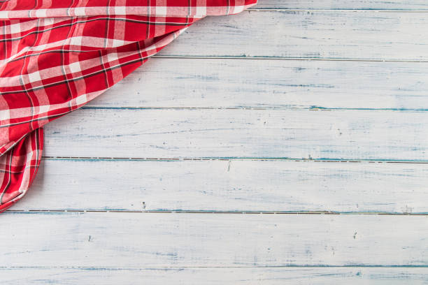 istock Top of view red checkered tablecloth on wooden table. 1030949328