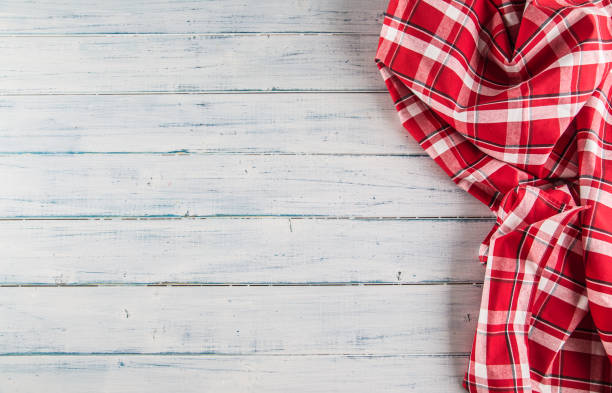 istock Top of view red checkered tablecloth on wooden table. 1030949346