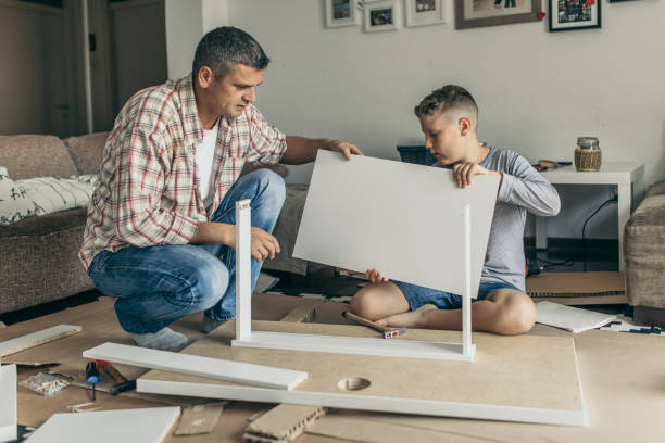 istock Single father is assembling furniture with his kids 1030949462