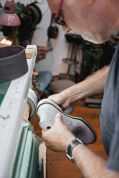 istock Shoemaker polishing shoes 1030949686
