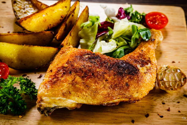 istock Roast chicken leg with fried potatoes and fresh vegetables 1030952028