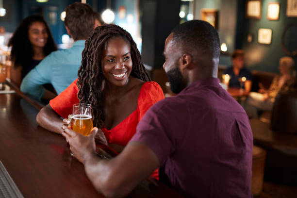 istock Couple On Date Sitting At Bar Counter And Talking 1030952304
