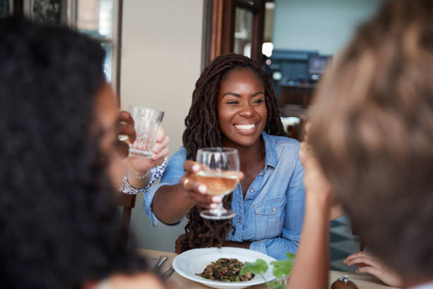 istock Friends Sitting At Table In Restaurant Making Toast Together 1030952888