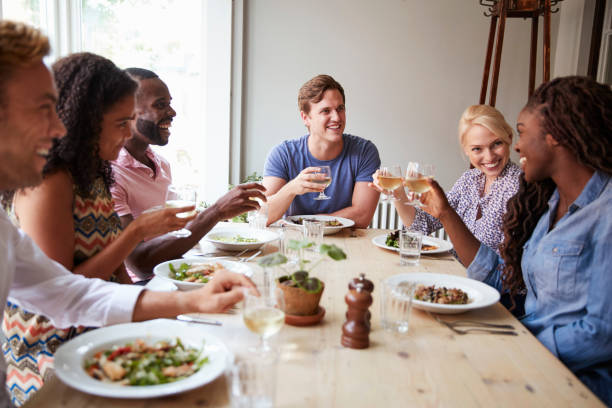 istock Friends Sitting At Table In Restaurant Making Toast Together 1030952912