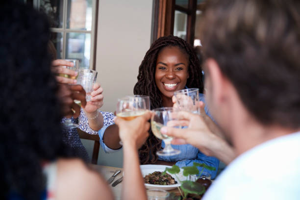 istock Friends Sitting At Table In Restaurant Making Toast Together 1030952928