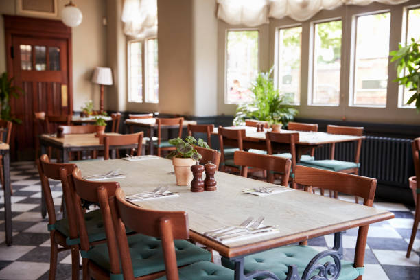 istock Tables Laid For Service In Empty Restaurant 1030953708