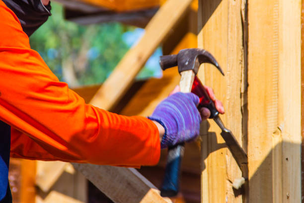 istock Carpenter is using chisel and hammer to groove vertical line. Close up hands of carpenter with chisel and hammer during grooving work. 1030956848