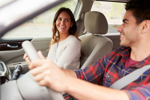 istock Young mixed race couple driving on holiday and smiling 1030958090