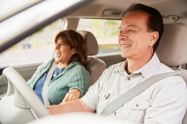 istock Senior mixed race couple sit smiling in car 1030960234
