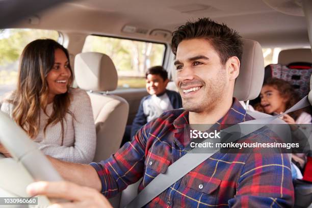 Mother Turns Around To Her Children On The Back Seat Of Car Stock Photo - Download Image Now