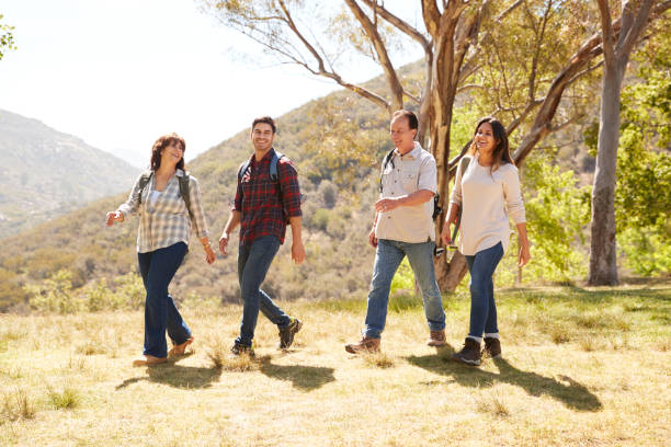 istock Couple and senior parents smiling during a mountain walk 1030969864
