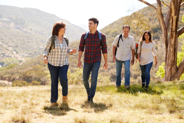 istock Couple and senior parents talking during a mountain walk 1030969874