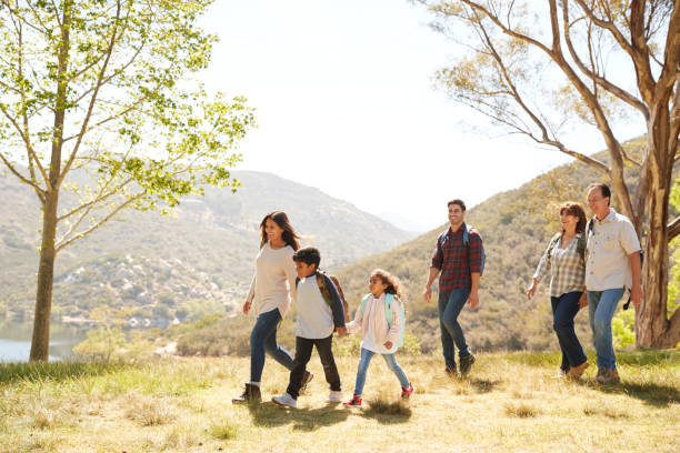 istock Multi generation family enjoying a hike by a mountain lake 1030969880