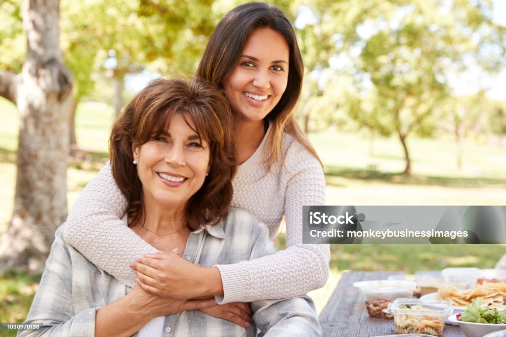 Senior mother and adult daughter embracing in park, close up Mother Stock Photo