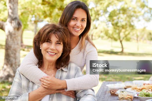 Senior Mother And Adult Daughter Embracing In Park Close Up Stock Photo - Download Image Now