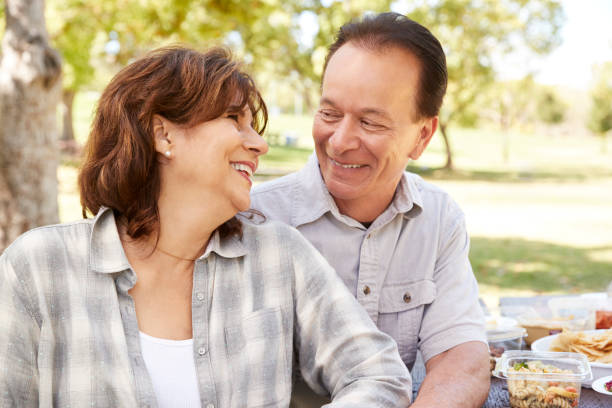 istock Senior couple sitting at picnic table during hike, portrait 1030970146