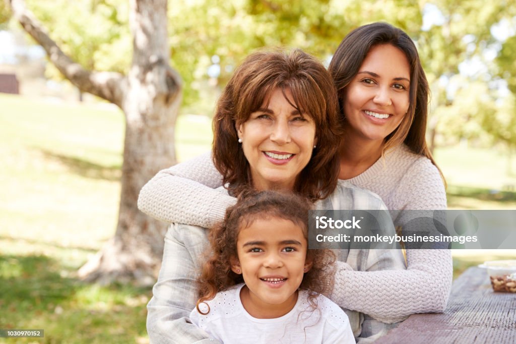 Three generations of women at a family picnic in a park Multi-Generation Family Stock Photo