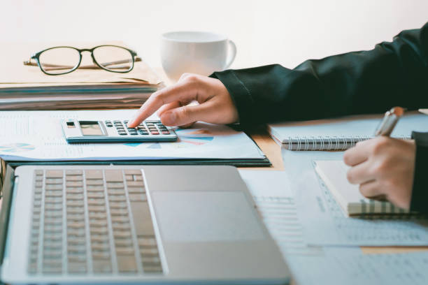 istock accountant working on desk and using calculator with pen in office. concept finance and accounting 1030972976