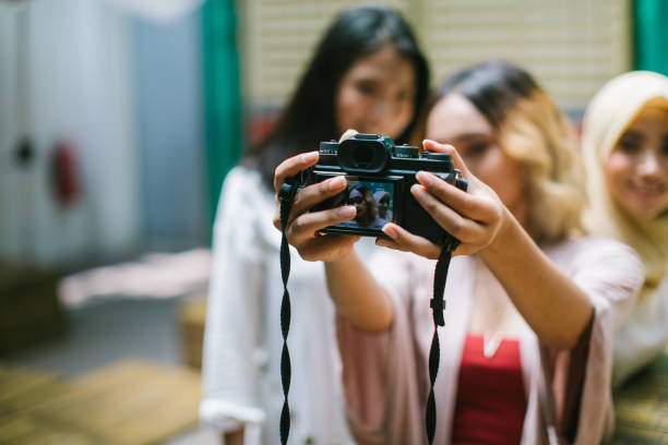 Capturing a happy moment Multi-ethnic group of women having fun taking a selfie in the cafe, Kuala Lumpur, Malaysia muslim photographer stock pictures, royalty-free photos & images