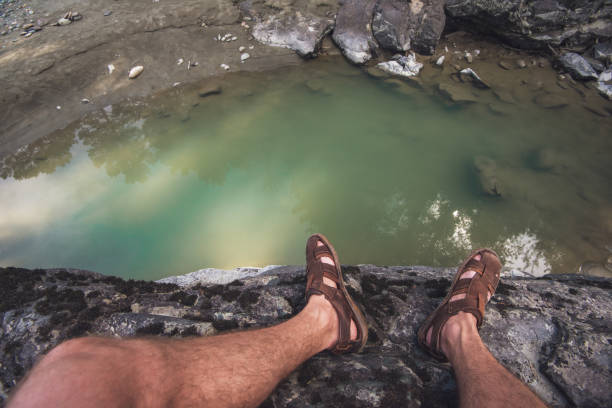 istock Man standing on top of cliff 1030973506