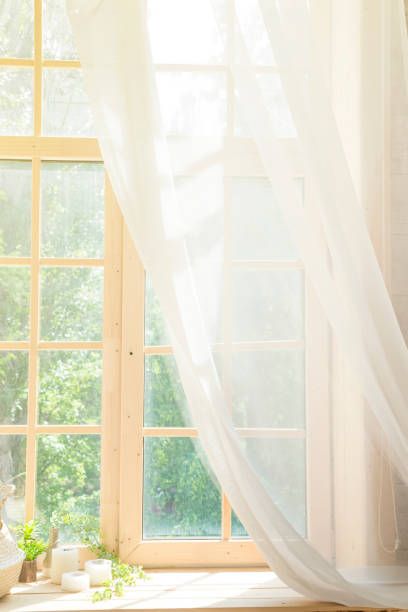 istock White Curtain and Wood Window Frame High key Background with sunlight 1030981456