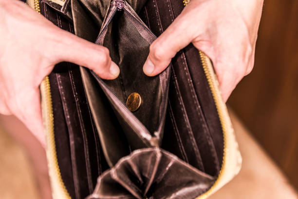 istock open blank purse with one coin, close-up 1030989304