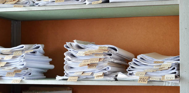 istock Old documents, drawings with numbers stacked on shelves in the office 1030992494