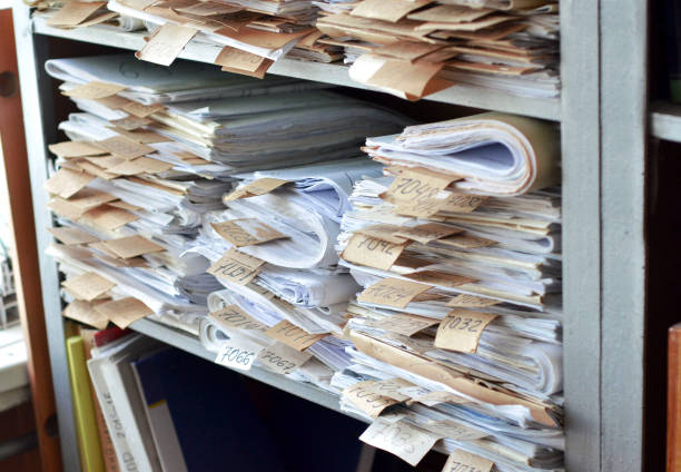 istock Old documents, drawings with numbers stacked on shelves in the office 1030992508