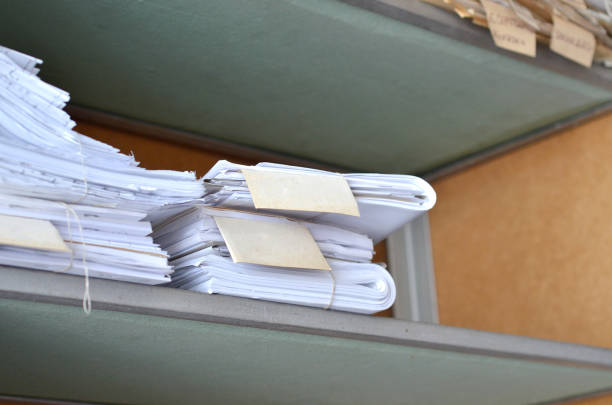 istock Old documents, drawings with numbers stacked on shelves in the office 1030992536