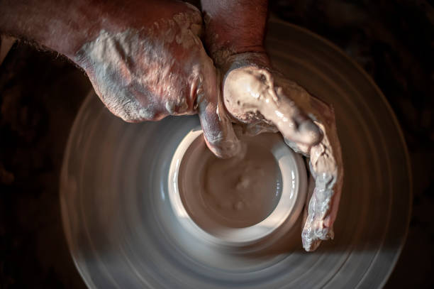 istock Hands of a potter cultivating clay 1030995628