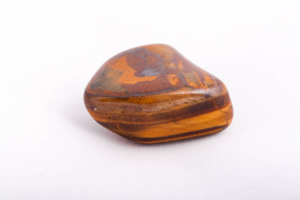 istock macro mineral stone tiger's eye on a white background 1030999052