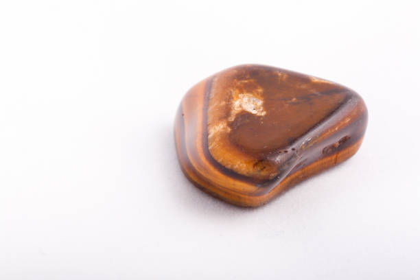 istock macro mineral stone tiger's eye on a white background 1030999120