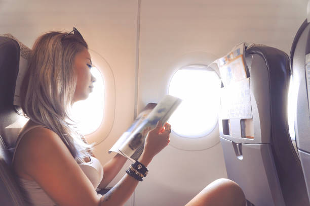 istock Woman is reading magazine in airplane 1031002122