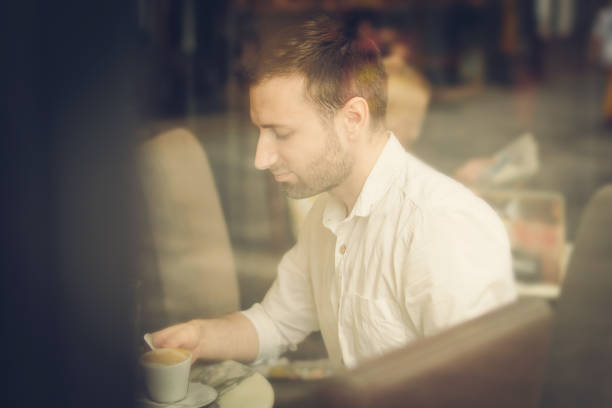 istock Young man sitting in coffee shop 1031006960