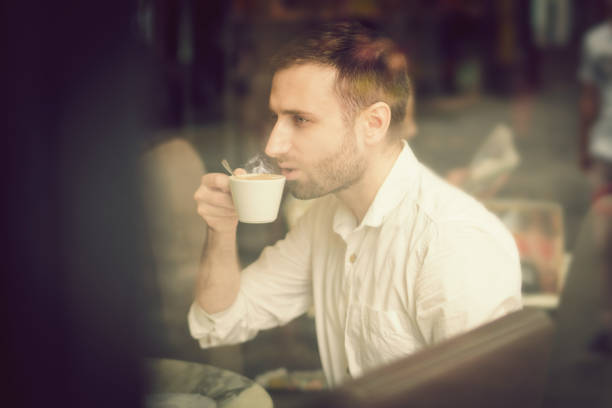 istock Young man sitting in coffee shop 1031007084