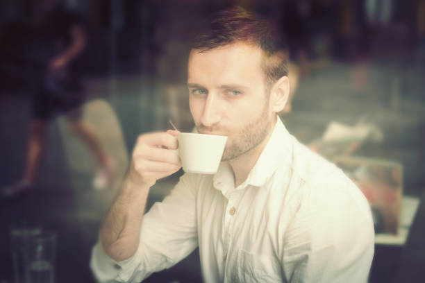 istock Young man sitting in coffee shop 1031007120